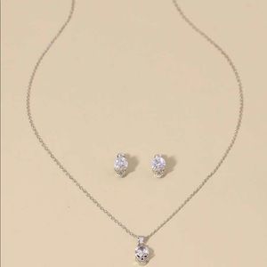 Silver skull necklace & rhinestone earrings